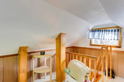 a attic room with a staircase and a window at Crestline Cabin Close to Lake Arrowhead and Skiing in Crestline