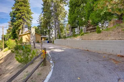 an empty street in front of a house at Crestline Cabin Close to Lake Arrowhead and Skiing in Crestline