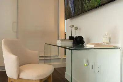 a white chair sitting next to a glass table at Stylish Condo By The Beach in Los Angeles