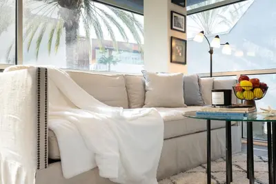 a living room with a white couch and a table at Stylish Condo By The Beach in Los Angeles