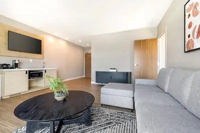 a living room with a couch and a table at Cambria Hotel Burbank Airport in Burbank