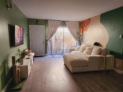 a living room with a couch and a window at Cozy Private Room & Bath Central Location LA in Los Angeles