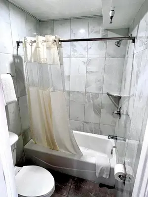 a bathroom with a tub and a toilet and a sink at Paradise Inn-Montebello,Los Angeles in Montebello
