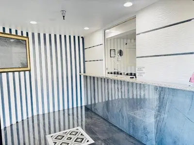 a bathroom with a blue and white striped wall at Paradise Inn-Montebello,Los Angeles in Montebello