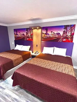 a hotel room with two beds and a painting on the wall at Paradise Inn-Montebello,Los Angeles in Montebello