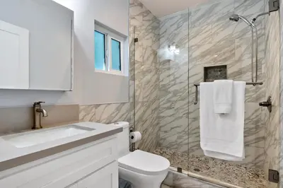 a bathroom with a sink and a toilet and a shower at Lovely North Hollywood House Near Universal in North Hollywood