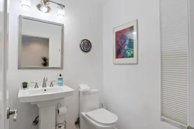 a bathroom with a sink and a toilet and a mirror at Lovely North Hollywood House Near Universal in North Hollywood
