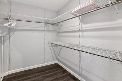 a walk in closet with white walls and metal shelves at Lovely North Hollywood House Near Universal in North Hollywood