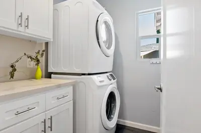 a white laundry room with a washer and dryer at Lovely North Hollywood House Near Universal in North Hollywood