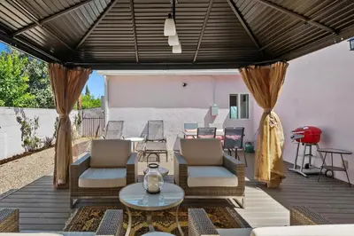 an outdoor patio with chairs and a table at Lovely North Hollywood House Near Universal in North Hollywood