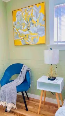 a room with a blue chair and a table with a lamp at Bonito descanso LAX 10 min SOFI 5 min in Hawthorne