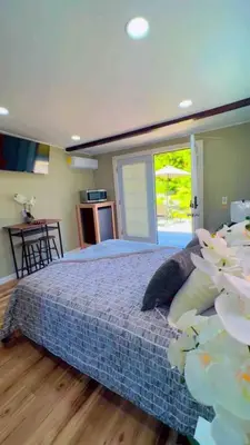 a bedroom with a bed and a large window at Bonito descanso LAX 10 min SOFI 5 min in Hawthorne