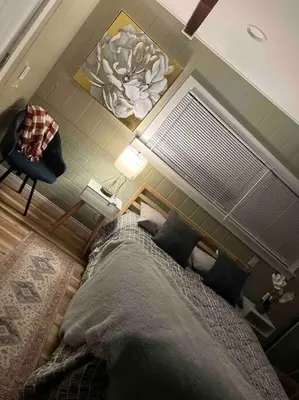 a bedroom with a large bed and a chair at Bonito descanso LAX 10 min SOFI 5 min in Hawthorne