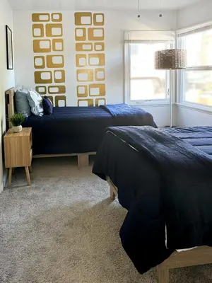 a bedroom with two beds and a couch at Quaint Mid-Century Cottage by the Coast in Ventura