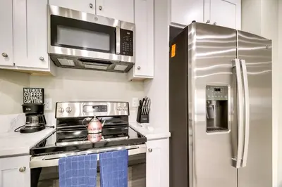 a kitchen with a stove and a microwave and a refrigerator at Fast WiFi and Free Parking Cozy Fontana Apartment in Fontana