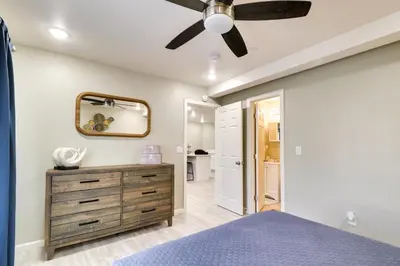 a bedroom with a ceiling fan and a blue bed at Fast WiFi and Free Parking Cozy Fontana Apartment in Fontana