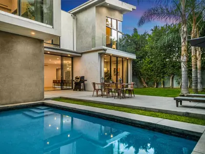 a house with a swimming pool in front of a house at Coldwater Canyon in Los Angeles