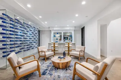 a room with chairs and a table and a wine cellar at Coldwater Canyon in Los Angeles
