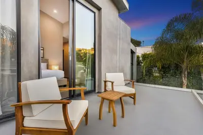 two chairs and a table on a balcony with a bedroom at Coldwater Canyon in Los Angeles