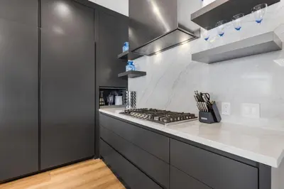 a kitchen with black cabinets and a stove at Escondido Escape in Malibu