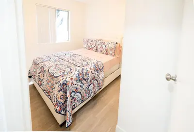 a small bedroom with a bed and a window at cozy small 2 bedroom in Koreatown/Hollywood in Los Angeles