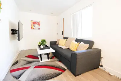 a living room with a couch and a rug at cozy small 2 bedroom in Koreatown/Hollywood in Los Angeles