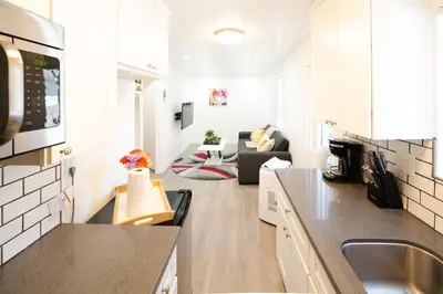 a kitchen and a living room with a couch at cozy small 2 bedroom in Koreatown/Hollywood in Los Angeles