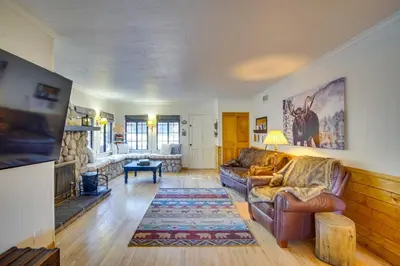 a living room with a couch and a fireplace at 1 Mi to Lake Home with Hot Tub and Gazebo in Big Bear in Big Bear Lake