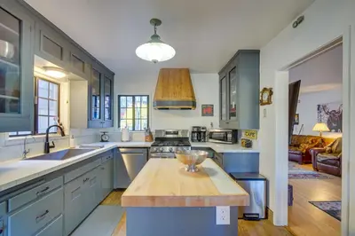 a kitchen with blue cabinets and a wooden counter top at 1 Mi to Lake Home with Hot Tub and Gazebo in Big Bear in Big Bear Lake