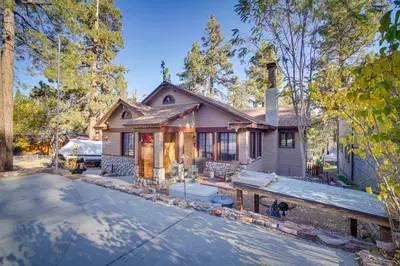 a home in the woods with a driveway at 1 Mi to Lake Home with Hot Tub and Gazebo in Big Bear in Big Bear Lake