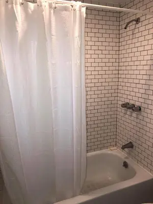 a bathroom with a white shower curtain and a tub at DTLA Oasis Private Bedroom with Exclusive Laundry - Steps to the Heartbeat of LA in Los Angeles