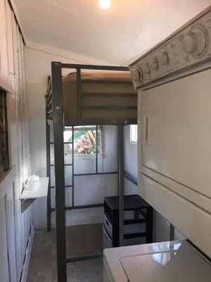 a small kitchen with a bunk bed in a tiny house at Urban Oasis with Private Laundry: Steps from DTLA in Los Angeles