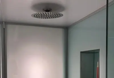 a bathroom with a ceiling fan and a mirror at Dogtown Loft in Los Angeles