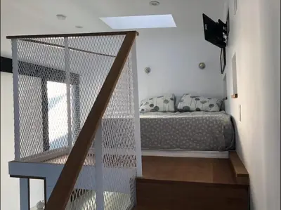 a bedroom with a bed and a stair case at Dogtown Loft in Los Angeles