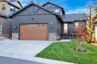 a gray house with a brown garage at Pine Meadow Village Castle~ Incredible Chalet Home in Big Bear Lake