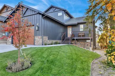 a large house with a driveway and grass at Pine Meadow Village Castle~ Incredible Chalet Home in Big Bear Lake