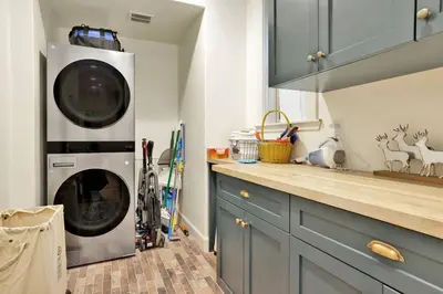 a kitchen with a washer and dryer in a kitchen at Pine Meadow Village Castle~ Incredible Chalet Home in Big Bear Lake