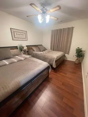 a bedroom with two beds and a ceiling fan at Beautiful, family friendly cabin by Lake Gregory. in Crestline
