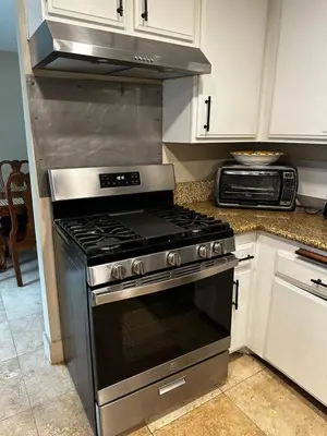 a kitchen with a stove top oven in a kitchen at Buxton Room in Rialto