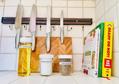 a row of knives hanging on a rack in a kitchen at 2 BR 2 BA - Eco House and Garden Vacation Retreat and Remote Workspace for Families, Couples and Solo Travelers in Coveted Culver in Culver City