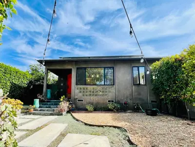 a house with a sign on the front of it at 2 BR 2 BA - Eco House and Garden Vacation Retreat and Remote Workspace for Families, Couples and Solo Travelers in Coveted Culver in Culver City