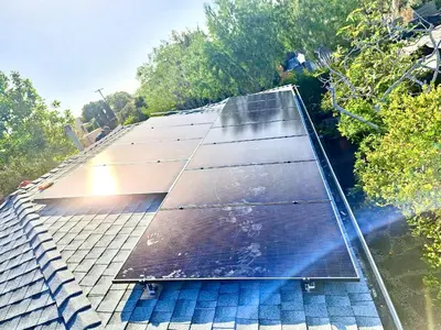 an array of solar panels on top of a roof at 2 BR 2 BA - Eco House and Garden Vacation Retreat and Remote Workspace for Families, Couples and Solo Travelers in Coveted Culver in Culver City