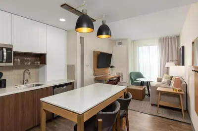 a kitchen and living room with a table and chairs at Staybridge Suites Eastvale - Norco by IHG in Eastvale