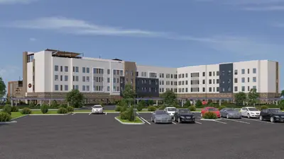 a large building with cars parked in a parking lot at Staybridge Suites Eastvale - Norco by IHG in Eastvale