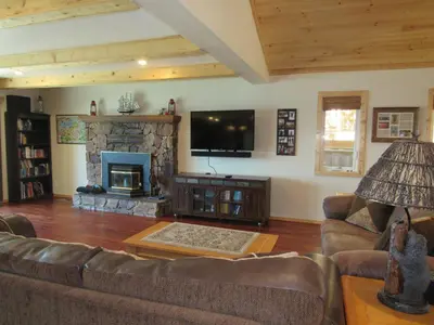 a living room with a couch and a fireplace at Smith Lakefront Hideaway in Big Bear Lake