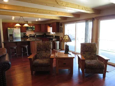 a living room with a table and chairs and a kitchen at Smith Lakefront Hideaway in Big Bear Lake