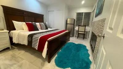 a bedroom with a bed and a blue rug at AB&B suite in Chino Hills