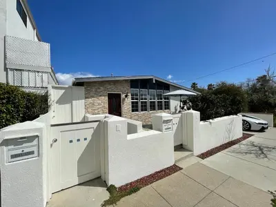 a white fence in front of a house at Your home away from home in beautiful Santa Monica in Los Angeles