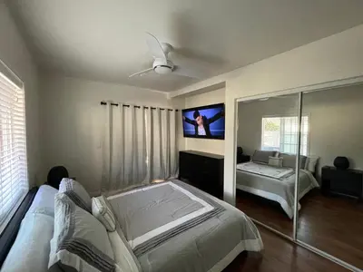 a bedroom with a bed and a flat screen tv at Your home away from home in beautiful Santa Monica in Los Angeles
