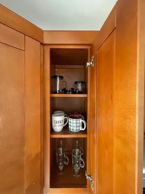 a cupboard with some pots and pans in it at Your home away from home in beautiful Santa Monica in Los Angeles